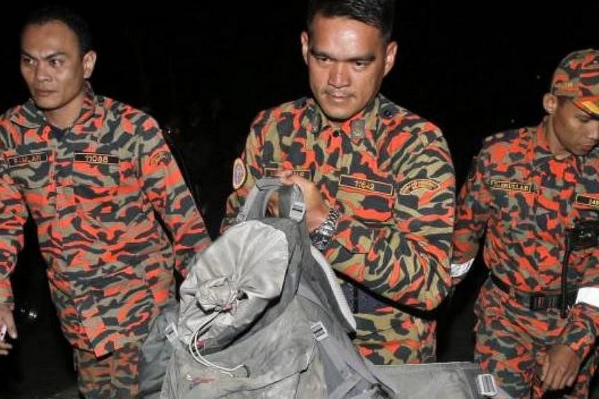 Efforts to bring down bodies of climbers from Mount Kinabalu have been hampered as some are crushed and pinned under tonnes of rocks and boulders after Friday's earthquake.&nbsp;-- PHOTO: THE STAR/ASIA NEWS NETWORK&nbsp;