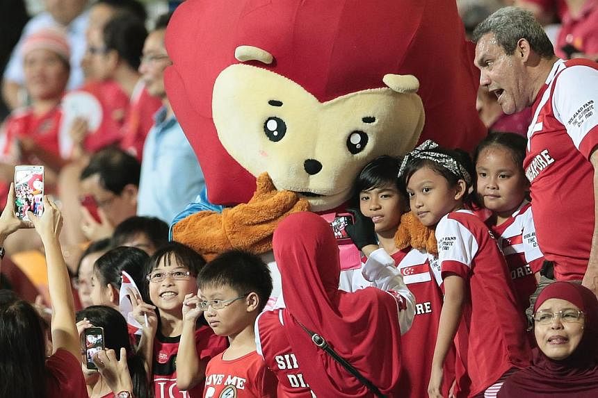 SEA Games mascot Nila posing with fans during the football match between Singapore and Philippines at the Jalan Besar Stadium on June 1, 2015. -- PHOTO: REUTERS