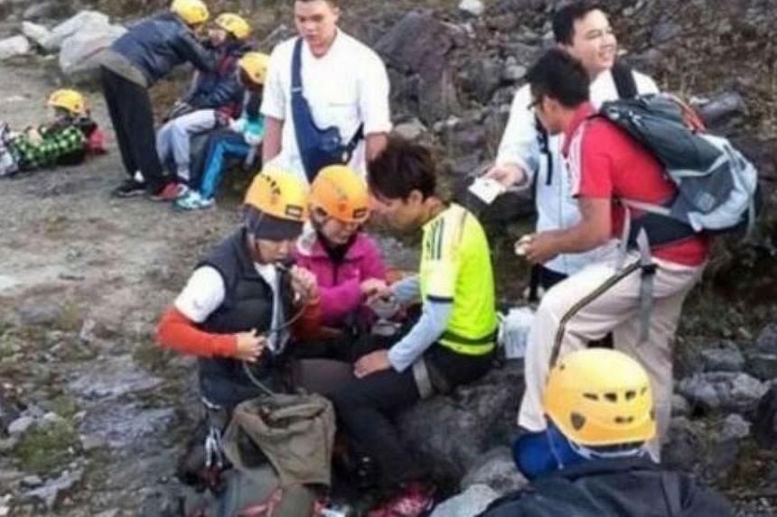 Climbers who were on the lower part of Mount Kinabalu taking a rest as they make their way to the safety. -- PHOTO: THE STAR/ASIA NEWS NETWORK