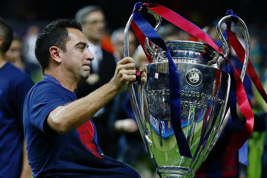 Barcelona's Xavi celebrates with the Champions League trophy after winning the UEFA Champions League Final between FC Barcelona and Juventus at the Olympiastadion, in Berlin, Germany, on June 6, 2015. -- PHOTO: REUTERS&nbsp;