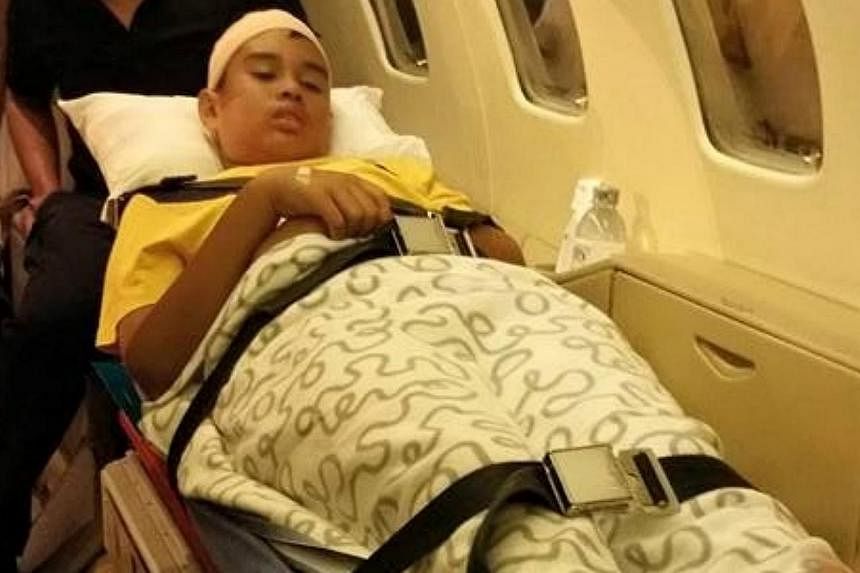Emyr Uzayr, 12, was flown back to Singapore with his parents on an International SOS air ambulance on Sunday morning (June 7). The other pupil took a separate flight. Both arrived at about 3am. -- PHOTO: NUR DAN SADRI/FACEBOOK&nbsp;