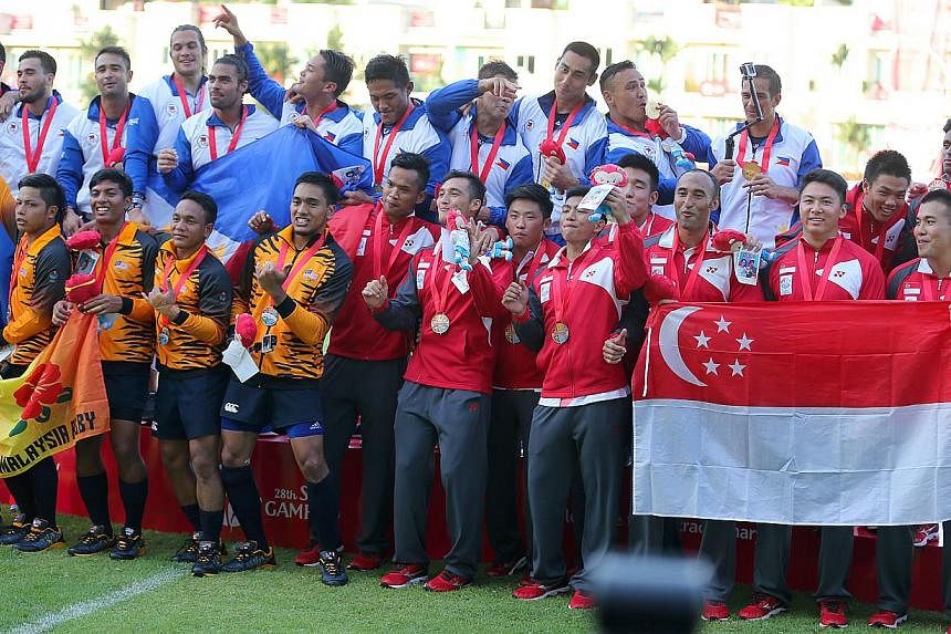 Singapore's SEA Games men's rugby 7s team (above) had to settle for a bronze medal, while the women took silver. -- PHOTO: THE NEW PAPER