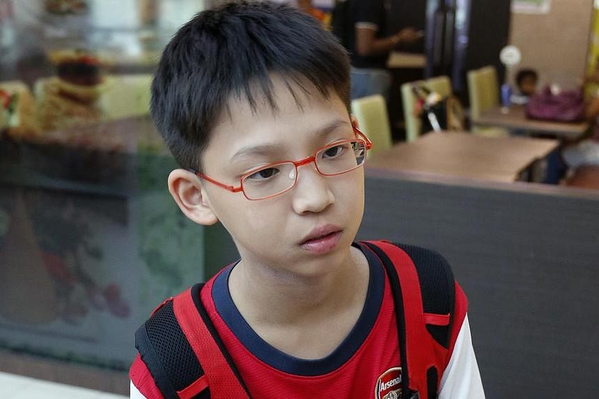 RIGHT: Primary Six pupil Ronan Lim fell and sprained his ankle in the rush and a Malaysian guide carried him the rest of the way down the mountain. BELOW: A distraught pupil from Tanjong Katong Primary School arriving at Changi Airport yesterday.