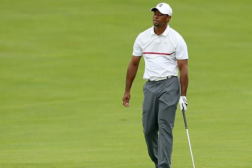 Tiger Woods reacts to a poor second shot on the 17th hole during the third round of The Memorial Tournament presented by Nationwide at Muirfield Village Golf Club on June 6, 2015 in Dublin, Ohio. -- PHOTO: AFP