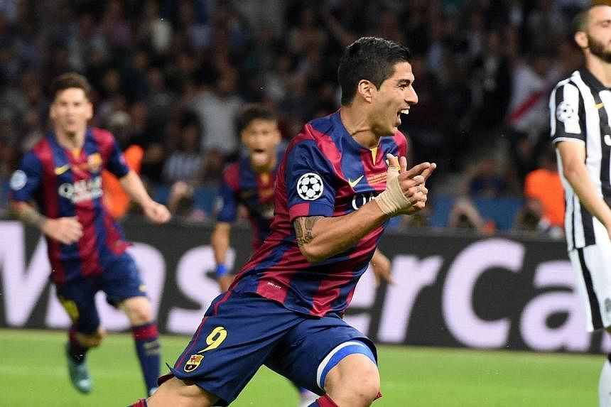 Barcelona's Luis Suarez (centre) celebrating after scoring to give his team a 2-1 lead during the UEFA Champions League final soccer match against Juventus during the Champions' League final at Olympiastadion in Berlin, Germany, on June 6, 2015. Addi