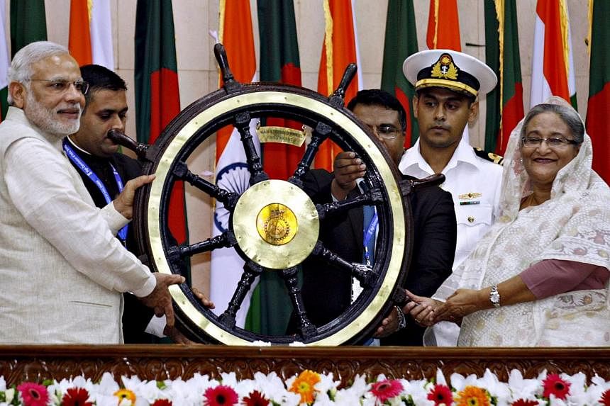 India's Prime Minister Narendra Modi (left) presents a ship's wheel to Bangladesh's Prime Minister Sheikh Hasina (right) in Dhaka on June 6, 2015. -- PHOTO: REUTERS