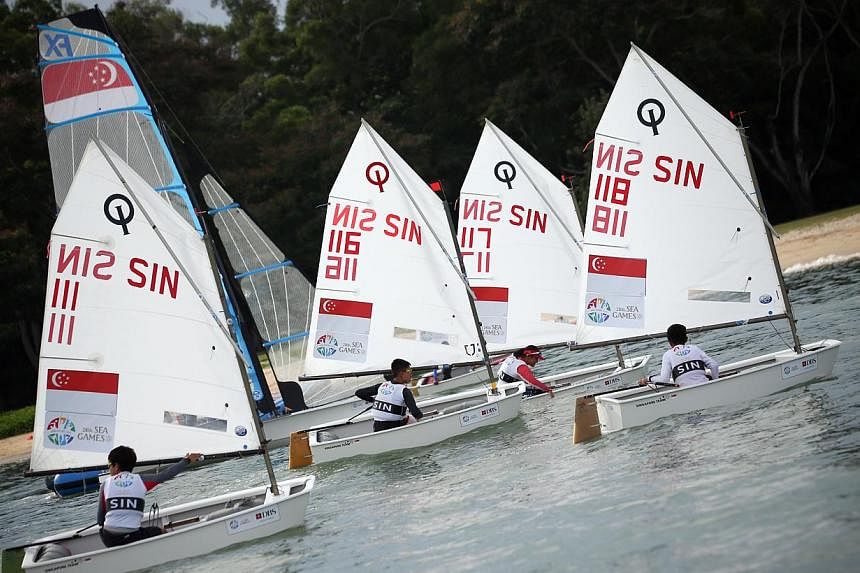 Singapore's optimist sailors had to settle for a SEA Games silver in the team event on Sunday afternoon, after they lost 2-0 to Malaysia in a best-of-three match race final. -- PHOTO: ZAO BAO