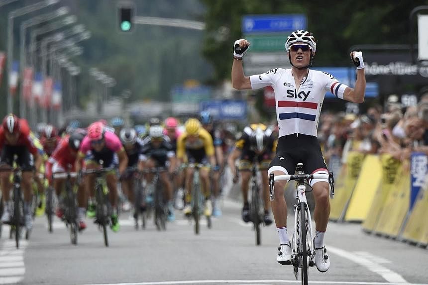 Great Britain's Peter Kennaugh celebrates as he crosses the finish line at the end of the 131.5 km first stage of the 67th edition of the Dauphine Criterium cycling race on Sunday (June 7) between Ugine and Albertville in the French Alps. -- PHOTO AF