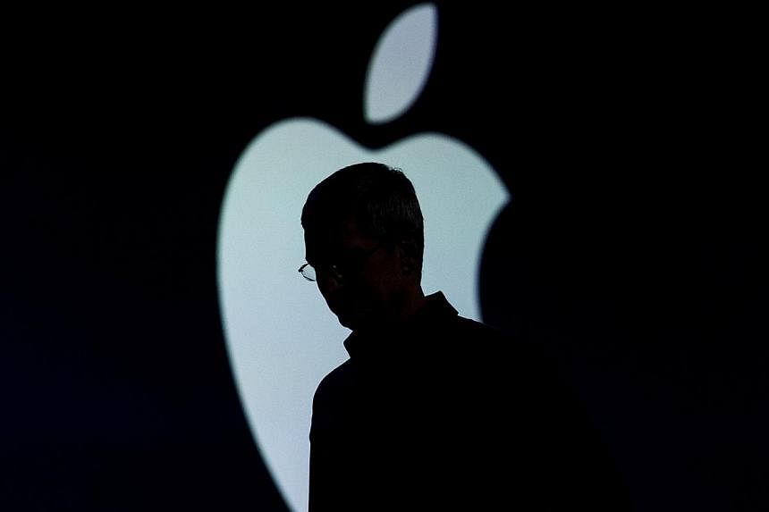 The silhouette of Tim Cook, chief executive officer of Apple Inc., is seen as he exits the stage during the Apple World Wide Developers Conference (WWDC) in San Francisco, California, US, on June 8, 2015. Apple unveiled a revamped streaming-music ser