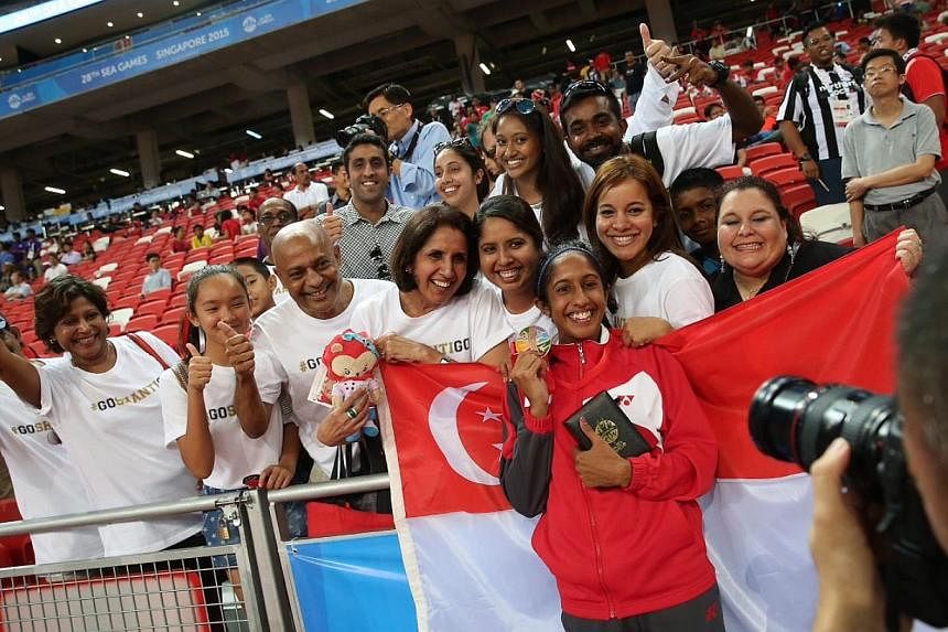 Singapore's Shanti Pereira (in red) posing with her family and friends after her bronze medal win. -- ST PHOTO: NEO XIAOBIN