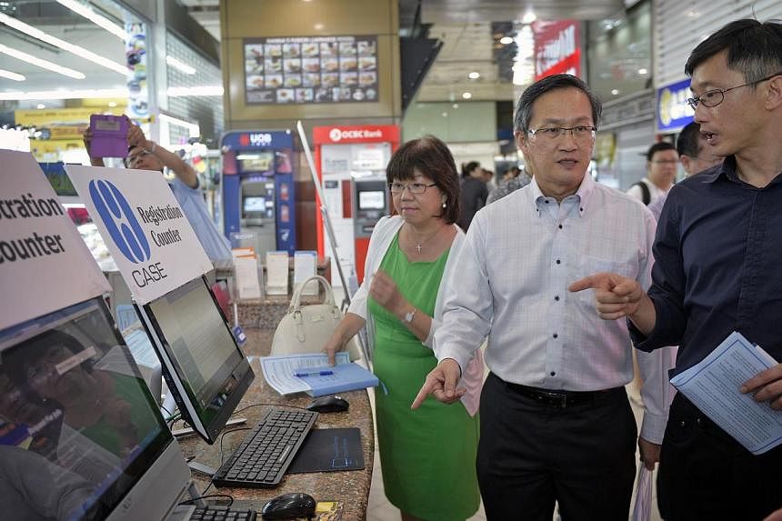 (Left to Right) Mayor for Central Singapore District Denise Phua, Consumers Association of Singapore (Case) president Lim Biow Chuan and Minister of State for Trade and Industry Teo Ser Luck visiting shops at Sim Lim Square on May 22, 2015. The Consu