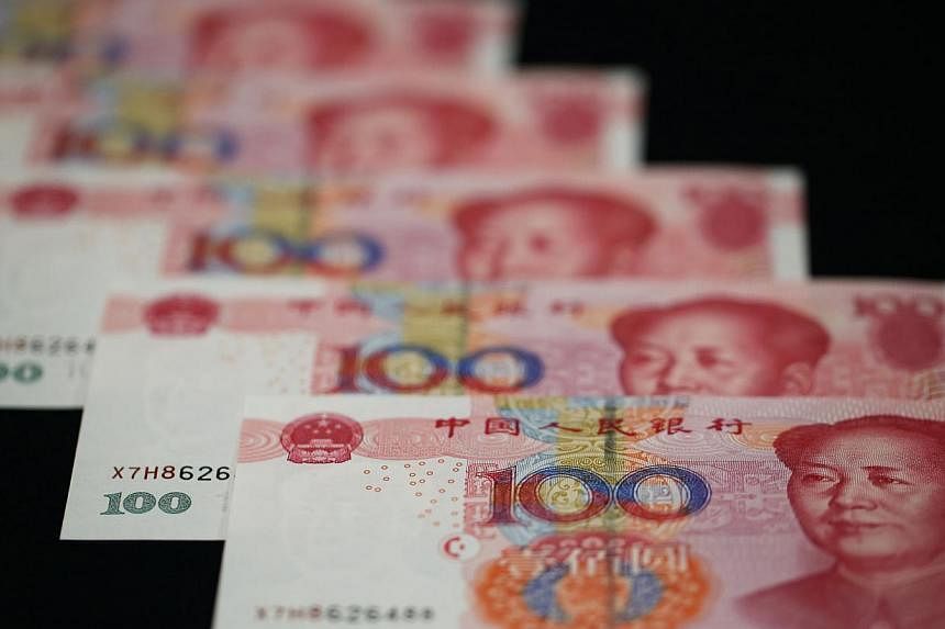 China's yuan inched up against the dollar on Tuesday, after the central bank set the official guidance rate higher. -- PHOTO: BLOOMBERG