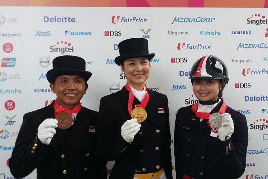 Indonesia's top dressage rider Gading Larasati (centre) with her SEA Games gold medal in the individual dressage event on June 9, 2015. Singapore's Caroline Chew (right) claimed silver while Gading's compatriot Menayang Alfaro (left) got the bronze. 