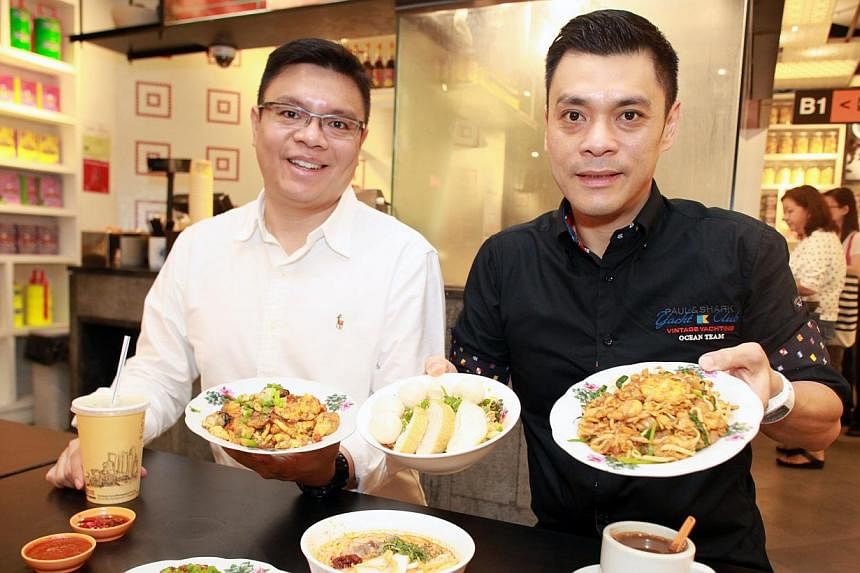 Fei Siong’s group managing director Tan Kim Siong (right) and executive director Tan Kim Leng (left) want to preserve Singapore’s food culture by getting old hawkers to share their recipes. -- PHOTO: MIKE LEE FOR THE STRAITS TIMES