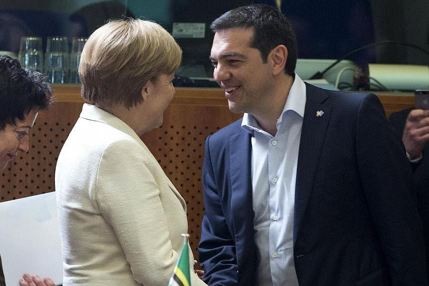 German Chancellor Angela Merkel (left) shakes hands with Greek Prime Minister Alexis Tsipras (right) at the start of an EU-CELAC Latin America summit in Brussels, Belgium on June 10, 2015. -- PHOTO: REUTERS