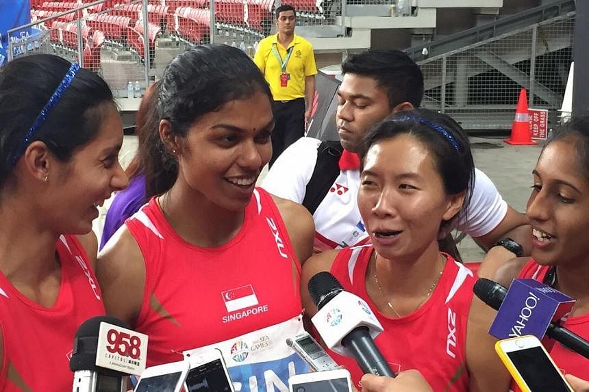 Singapore's 4x400m relay quartet of (from left) Dipna Lim-Prasad, T. Piriyah,&nbsp;Goh Chui Ling and Shanti Pereira smashed a 41-year-old national record but could only finish fourth. -- ST PHOTO: MAY CHEN