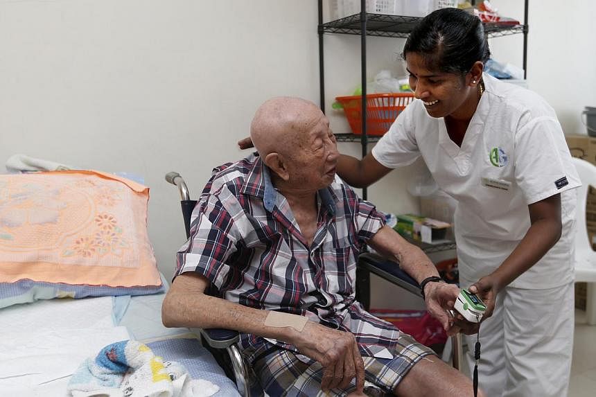 Ms Swaroopa Rani, a nurse from India, takes care of Mr Goh Chong Huat at his home near Bedok. He used to be in and out of hospital every month, but has not had to be hospitalised since Ms Rani started caring for him.