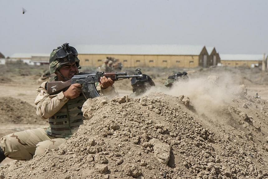 Iraqi soldiers train with members of the US Army 3rd Brigade Combat Team, 82nd Airborne Division, at Camp Taji, Iraq, on June 2, 2015.&nbsp;US President Barack Obama on Wednesday, June 10, approved the deployment of up to 450 more US military personn
