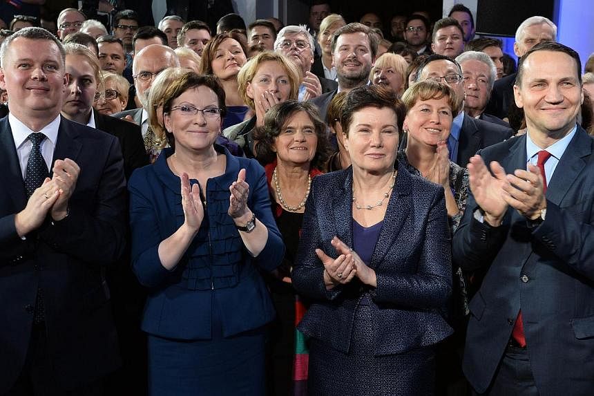 (Front row, from left) Poland's Defence Minister Tomasz Siemoniak, Prime Minister Ewa Kopacz, Warsaw Mayor Hanna Gronkiewicz-Waltz and Speaker of the Parliament Radoslaw Sikorski applauding after the announcement of Poland's local election results in