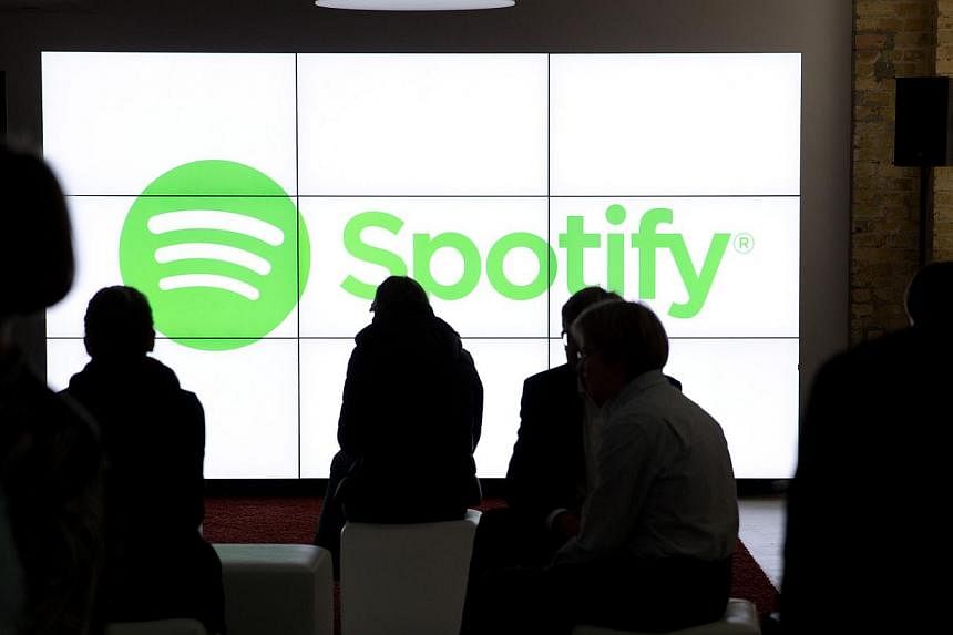 People wait for the start of an event by music streaming service Spotify in Berlin on May 20, 2015.&nbsp;Prosecutors in two US states are investigating whether major music labels have colluded to prevent competition in the booming area of music strea