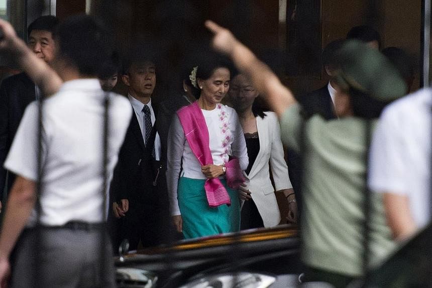 Myanmar pro-democracy leader Aung San Suu Kyi leaves the airport following her arrival in Beijing on June 10, 2015. -- PHOTO: AFP&nbsp;