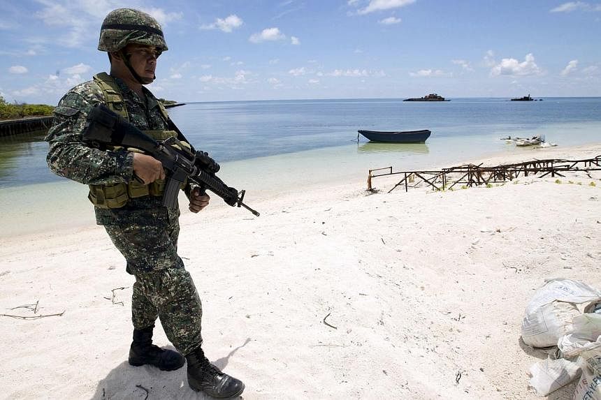 A Filipino soldier patrols the shore of Pagasa island (Thitu Island) in the Spratly group of islands in the South China Sea, west of Palawan, Philippines, in this May 11, 2015 file photo. -- PHOTO: REUTERS&nbsp;