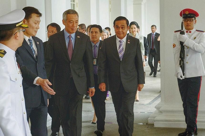Prime Minister Lee Hsien Loong with his Thai counterpart, General Prayut Chan-o-cha, who is in Singapore for a two-day introductory visit. -- ST PHOTO: DESMOND WEE