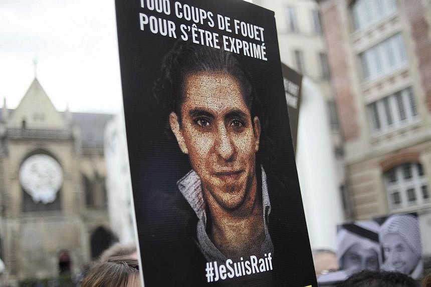 People demonstrate in support of Raif Badawi, who was sentenced to 1,000 lashes for "insulting Islam", on May 7, 2015, in Paris. -- PHOTO: AFP