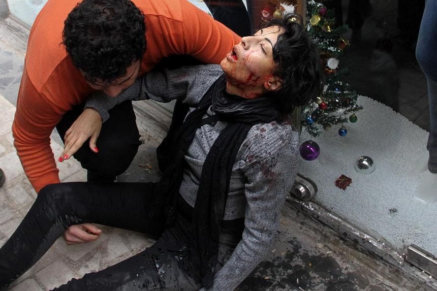 A file picture taken on Jan 24, 2015, shows Egyptian Shaima al-Sabbagh receiving assistance after she was injured during clashes with police during a rare leftwing protest in central Cairo, the eve of the anniversary of the 2011 uprising against Hosn