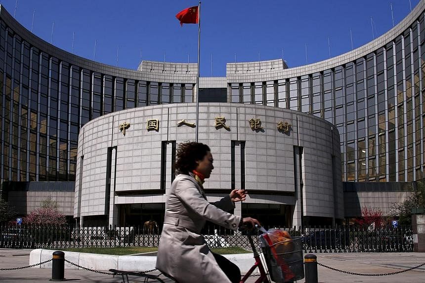 The People's Bank of China may lower the amount lenders must set aside as reserves by as much as 100 basis points this weekend to 17.5 per cent, making it the third reduction this year. -- PHOTO: REUTERS &nbsp;