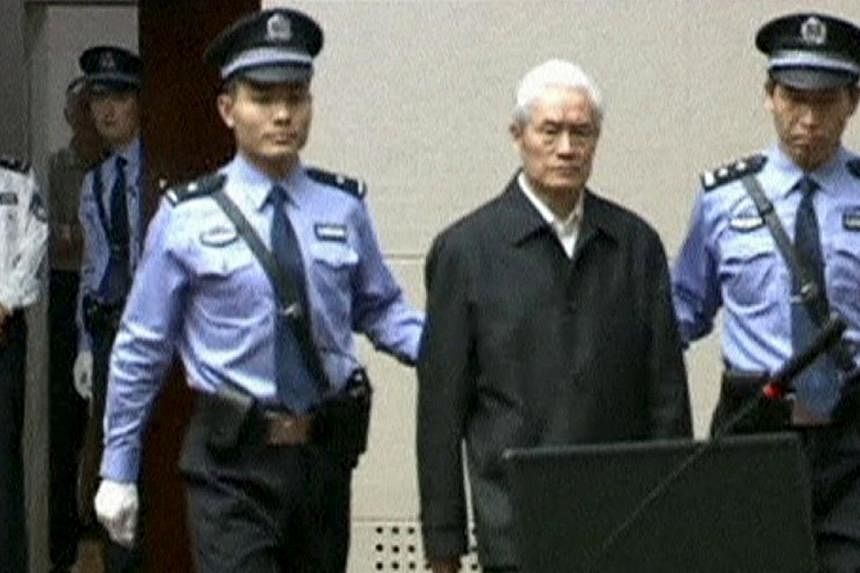 China's former domestic security chief Zhou Yongkang being escorted into court for his sentencing in Tianjin, China, in this still image taken from video provided by China Central Television and shot on June 11, 2015. -- PHOTO: REUTERS