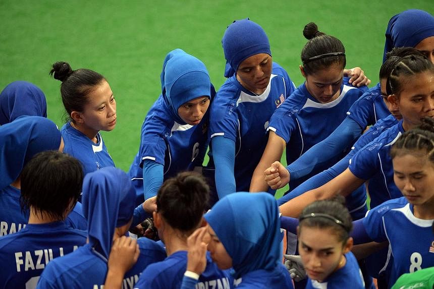 Malaysia's field hockey team huddle before the women's gold medal match against Thailand at the 28th Southeast Asian Games (SEA Games) in Singapore on June 12, 2015. -- PHOTO: AFP &nbsp;
