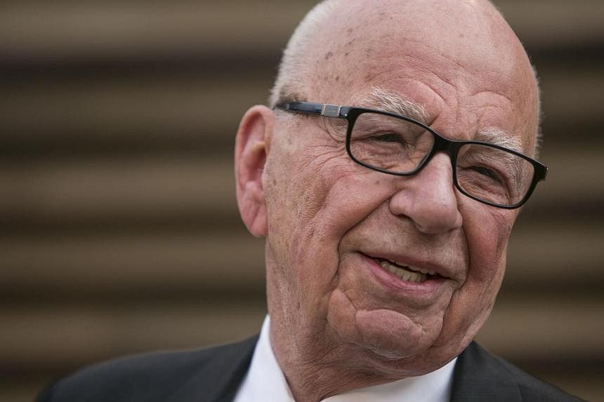 Rupert Murdoch (above, in 2014), who is to step down as chief executive of 21st Century Fox, the media-entertainment conglomerate, still sits at the top of a massive empire. -- PHOTO: AFP