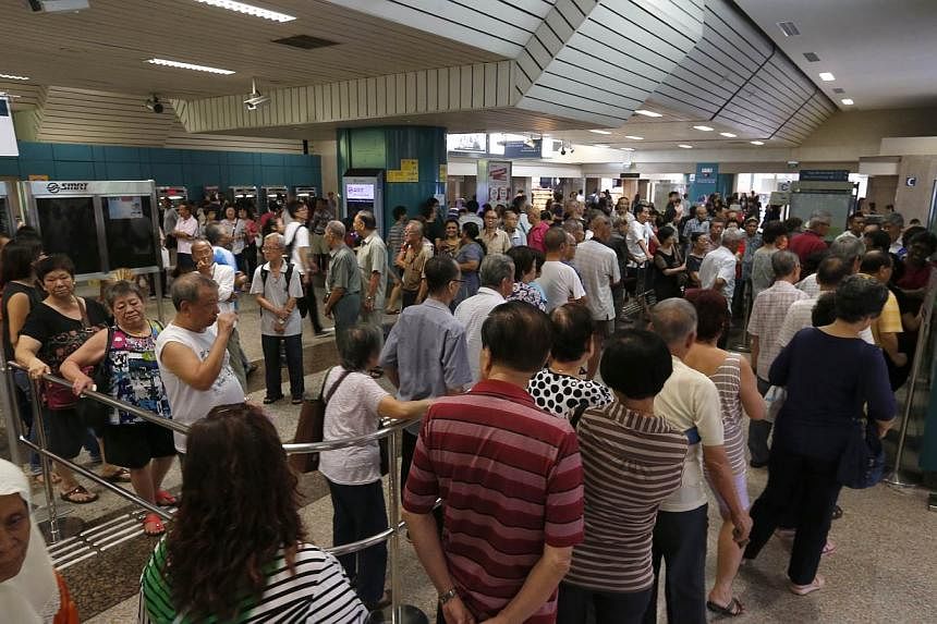 The queue at Ang Mo Kio MRT Station at 4.30pm on Friday (June 12). "There is no need to rush to redeem the voucher as the redemption period is until the end of next year (Dec 31, 2016)," said the Ministry of Health and the Ministry of Transport in a 