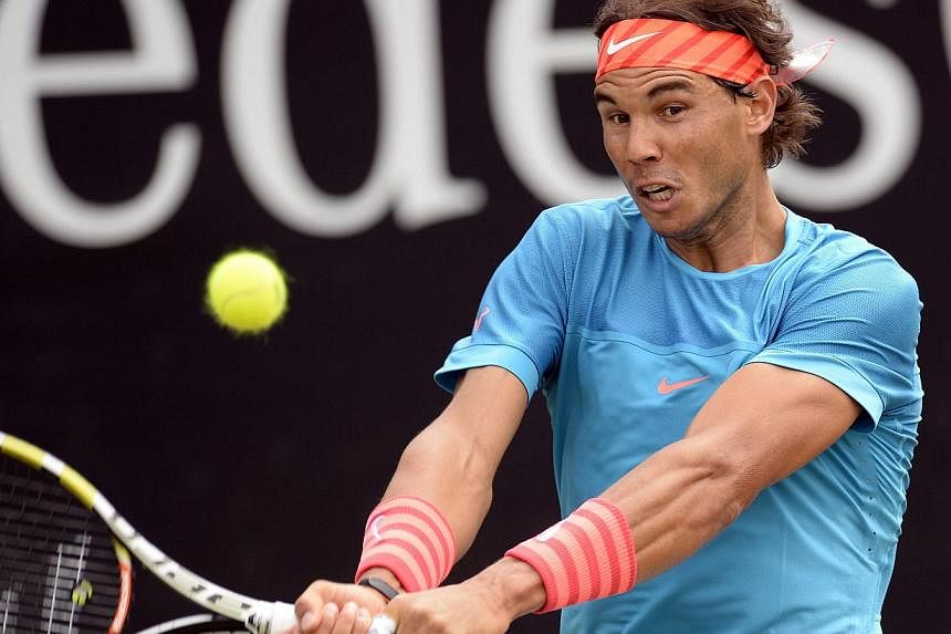 Spain's Rafael Nadal returns the ball to Marcos Baghdatis of Cyprus at the ATP Mercedes Cup in Stuttgart, southern Germany, on June 11, 2015. -- PHOTO: AFP&nbsp;