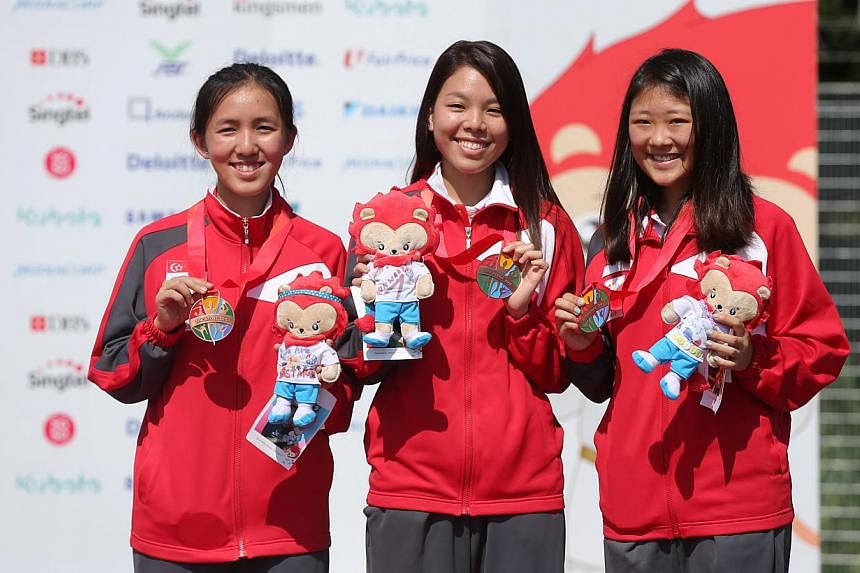 (From left) Shooters Jasmine Ser, Cheng Jian Huan and Li Yafei after winning a bronze in the women's 50m rifle prone team event on June 10, 2015. The trio also won bronze in the women's 50m rifle three-positions event on June 12. -- ST PHOTO: ONG WEE