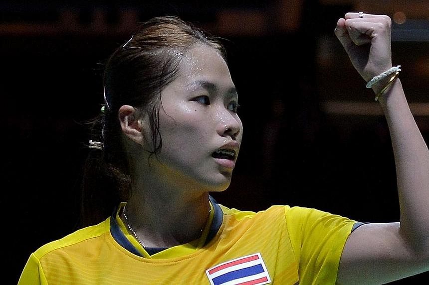 Ratchanok Intanon of Thailand reacts after winning a point against Lim Yin Fun of Malaysia in their women's team badminton final match during the 28th SEA Games in Singapore on June 12, 2015. -- PHOTO: AFP&nbsp;