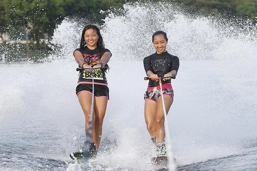 Waterskiing sisters Kalya (left) and Sabelle Kee were unable to get a gold medal in the women's trick competition, which was won by Malaysia's Aaliyah Hanifah-Yoong, at the Bedok Reservoir on June 12, 2015. -- ST PHOTO: KEVIN LIM