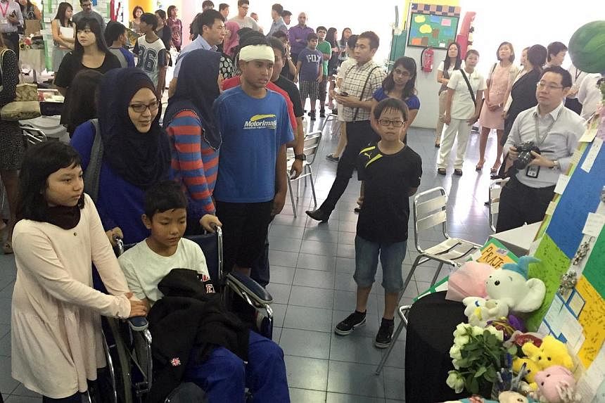 Tanjong Katong Primary School pupil El Wafeeq El Jauzy (in wheelchair), who survived the earthquake. -- PHOTO: THE NEW PAPER&nbsp;