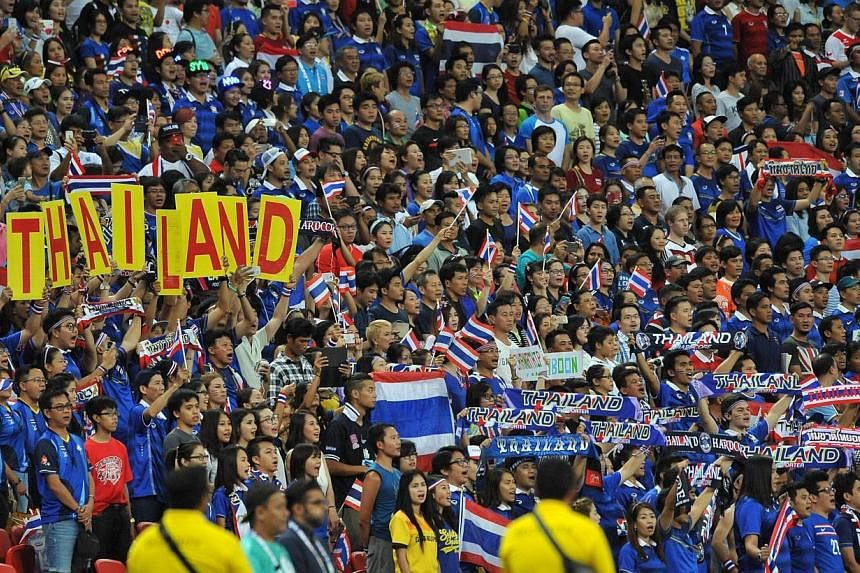 Thai supporters cheering on their team in the stands. -- PHOTO: AFP&nbsp;