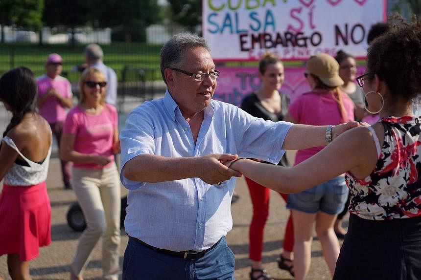 Activists giving free salsa lessons to promote the normalisation of relations between Cuba and the US outside of the White House on June 11, 2015, in Washington, DC. The Obama administration is expected to announce an agreement with Cuba in early Jul