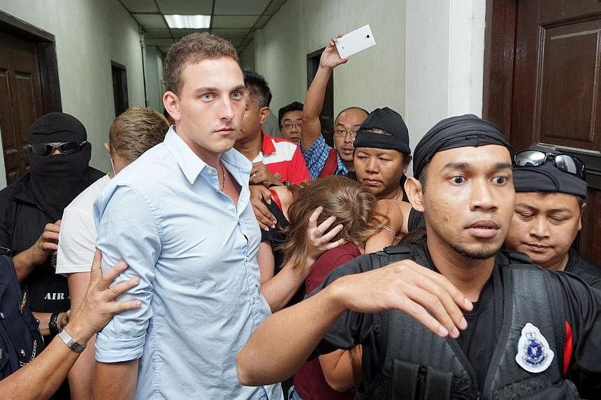 Dutch national Dylan Snel (centre) leaving a court hearing along with Canadian siblings Lindsey (third from left, obscured) and Danielle Petersen (in black, with face obscured) and British national Eleanor Hawkins (third from right, obscured) in Kota