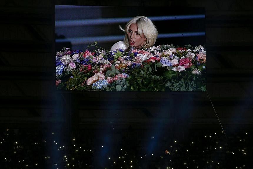 Pop star Lady Gaga is seen on a videowall while fans light their phones during the opening ceremony of the 1st European Games in Baku, Azerbaijan, on June 12, 2015. -- PHOTO: REUTERS