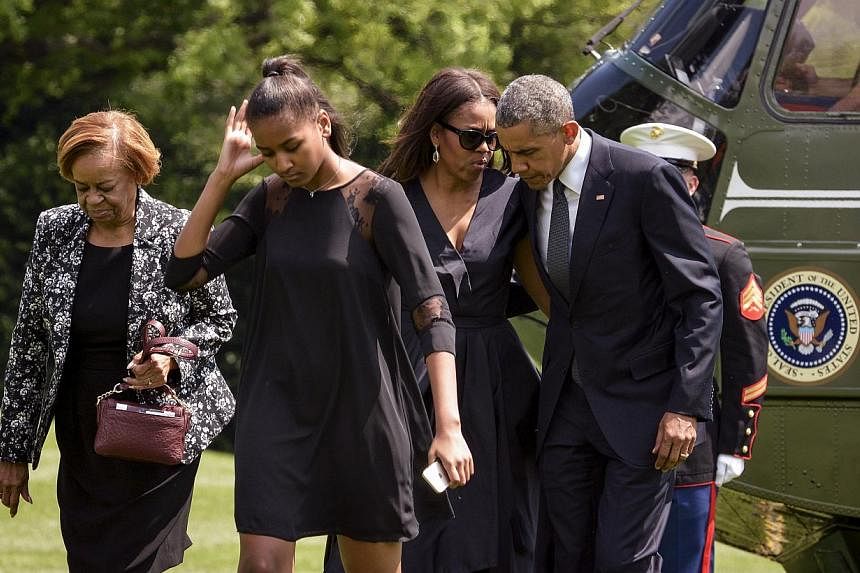 US President Barack Obama with first lady Michelle Obama, their daughter Sasha (second from left) and his mother in-law Marian Robinson (left). -- PHOTO: REUTERS &nbsp;