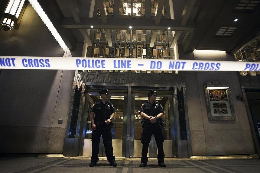 Police stand guard at the main entrance to the Waldorf Astoria Hotel following a shooting in the lobby during a wedding in the Manhattan borough of New York, on June 13, 2015. -- PHOTO: REUTERS