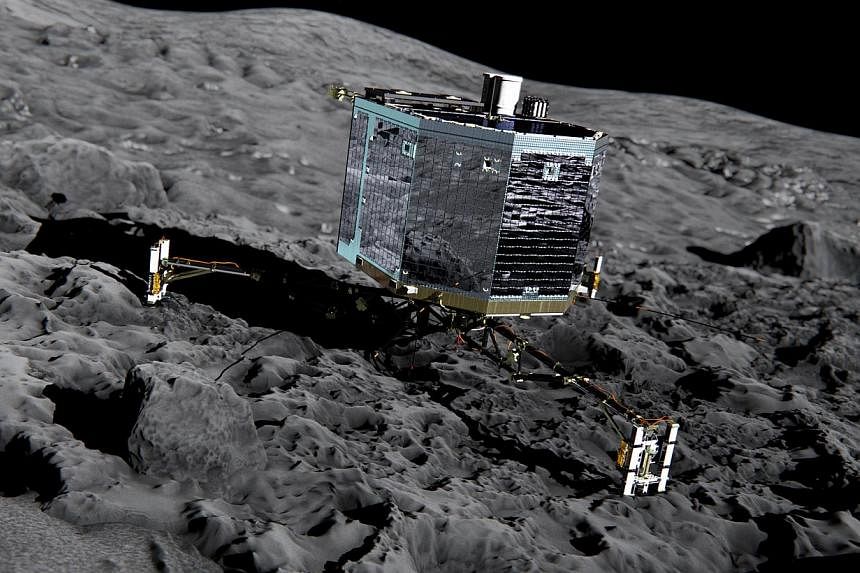 This file picture released by the European Space Agency on Dec 20, 2013 of an artist’s impression of Rosetta’s lander Philae (front view) on the surface of comet 67P/Churyumov-Gerasimenko.&nbsp;Europe's comet lander Philae has woken up overnight 