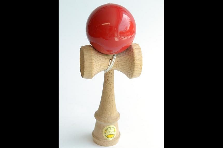 Simple wooden toy, Kendama (above). -- ST PHOTO: DESMOND WEE