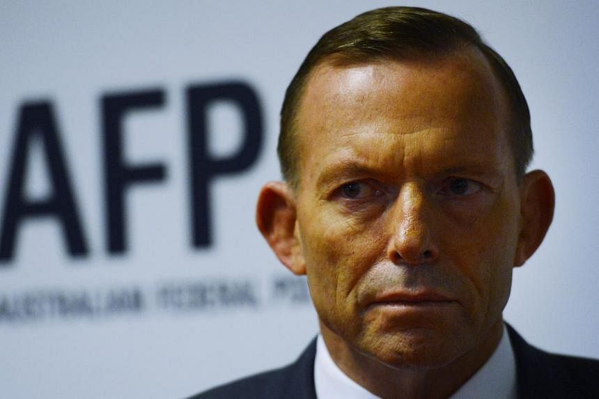 Australian Prime Minister Tony Abbott refused again on Sunday to deny allegations an official paid thousands of dollars to turn back a boatload of asylum-seekers, despite calls from Indonesia for answers. -- PHOTO: EPA