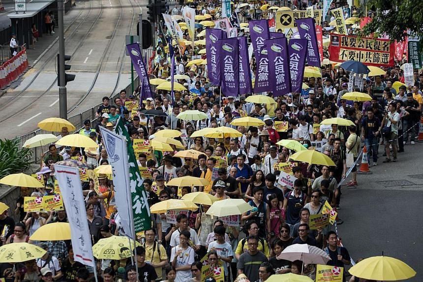 People marching during a pro-democracy rally in Hong Kong on June 14, 2015. The turnout is smaller than expected. -- PHOTO: AFP