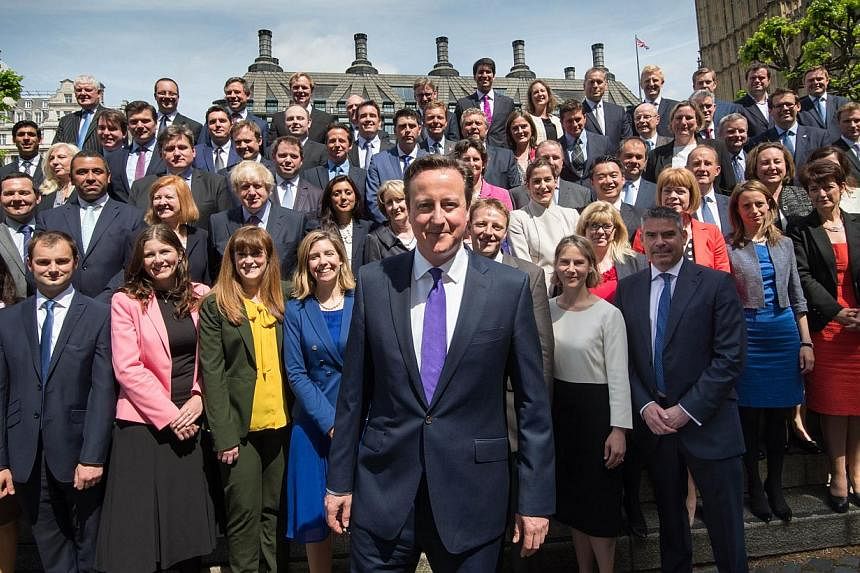 British Prime Minister David Cameron (centre) poses for a group photo with newly-elected Conservative MPs at the Houses of Parliament in central London on May 11, 2015. -- PHOTO: AFP